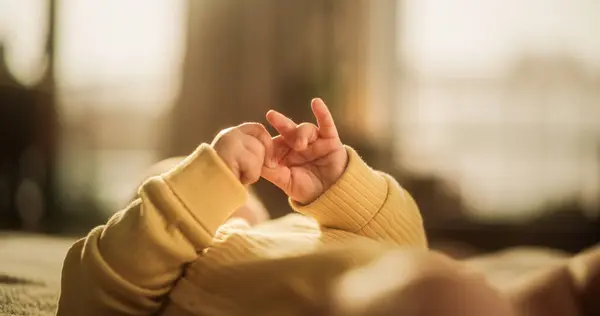 stock image Close-Up on the Hands of a Cute Baby in a Yellow Jumper. Little Active Toddler Trying to Communicate and Cooing. Little Palms Ready to Discover the