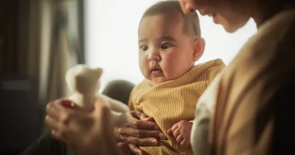 stock image Mother and Baby Bonding Moment: Authentic Shot of an Asian Woman New to Motherhood Playing with her Cute Child in the Peaceful Morning at Home. Mother