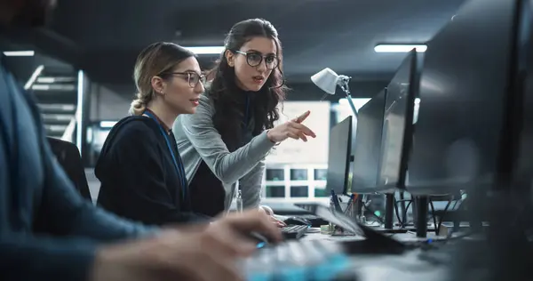 Stock image Two Beautiful Women Working in a Cyber Security Software Development Department. Young Manager Updating Software Developer on the Artificial