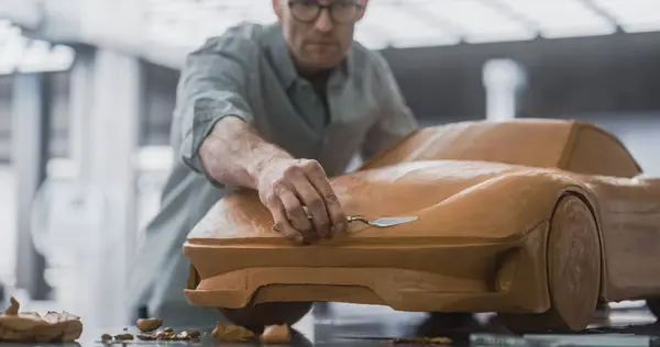 stock image Close Up Portrait of an Automotive Designer Sculpting a 3D Clay Model of a New Production Car. Professional Engineer Using a Spatula to Carefully