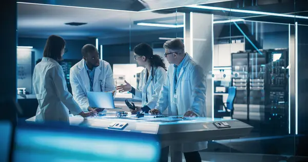 stock image Team of Tech Scientists Having a Group Meeting in Research and Development Facility at a Robot Manufacturing Factory. Engineers Examining an