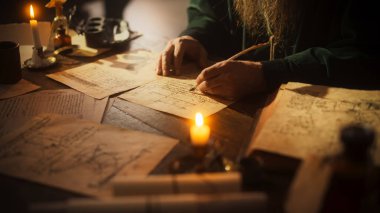 Close Up on Hand of Old Renaissance Male Using Ink and Quill to Write New Ideas. Dedicated Historian Taking Notes, Writing a Book about the Important clipart