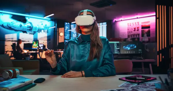 stock image Portrait of Young Adult Female Using Virtual Reality Goggles in Creative Office. Woman Using Futuristic Augmented Reality Software for Managing