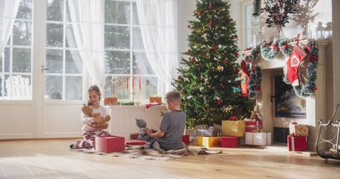 Pijamalı şirin çocuklar Noel sabahında hediyelerini alıyorlar. Tatil Paketleri 'ni açarken Mutlu Çocuklar Şaşırıyor, Alınıyor