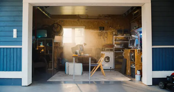 stock image Establishing Shot Of Empty Workplace With Old Desktop Computer In Retro Garage With Random Home Appliances. First Office Of Successful Computer