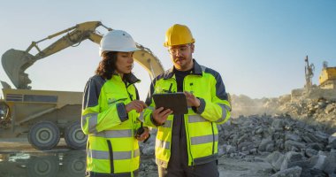 Caucasian Male Civil Engineer Using Tablet And Talking To Hispanic Female Architect On Construction Site Of New Real Estate Project. Diverse clipart