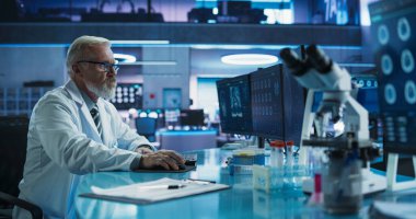 Senior Male Neuroscientist Using Desktop Computer To Analyze MRI Scans Of Brain In Medical Research Center Lab. Caucasian Doctor Studying CT Scan Of clipart