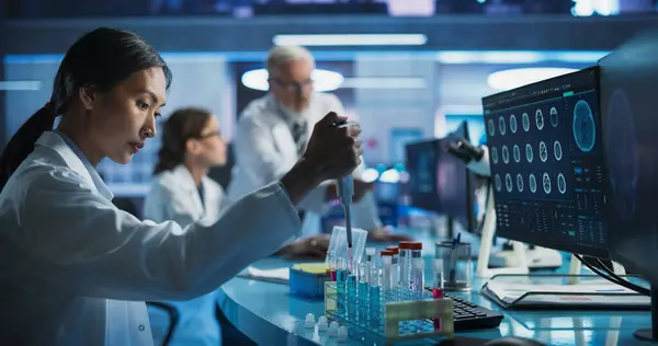 stock image Biotechnology Research Laboratory: Female Asian Doctor Working With Test Tubes To Study Effect Of Innovative Alzheimers Medicine. Focus Shifting To