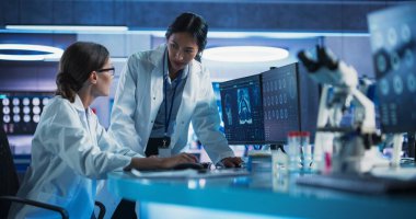 Medical Hospital Research Laboratory: Caucasian And Asian Female Scientists Talking And Using Desktop Computer With MRI Scans Of Human Brain. Surgeon clipart