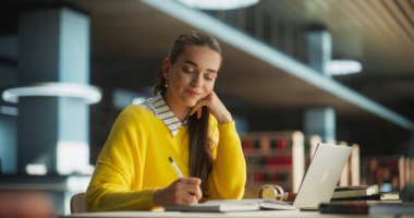 Çekici Çok Irklı Öğrenci Laptop Bilgisayarına Sosyal Bilimler Kompozisyonu Yazıyor ve Not Defterine Not Alıyor. Genç Şık Kadın Çalışması