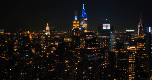 Aerial Shot of Office Buildings Late in the Evening. Rooms Have Lights On, Businesspeople and Managers Working Long Hours in New York City. Helicopter