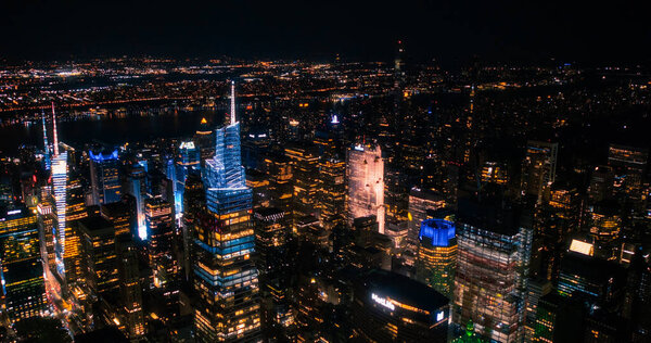 Helicopter Tour of New York City Architecture at Night. Midtown Manhattan Office Buildings and Skyscrapers Towards Madison Square Garden. Aerial Urban