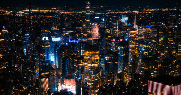 Aerial Image of Office Buildings at Night. Rooms Have Lights On, Businesspeople and Managers Working Long Hours in New York City. Helicopter Cityscape