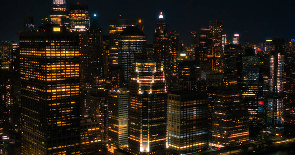 Wall Street Office Buildings Lit Up at Night: Scenic Aerial New York City View of Lower Manhattan Architecture. Panoramic Financial District Photo