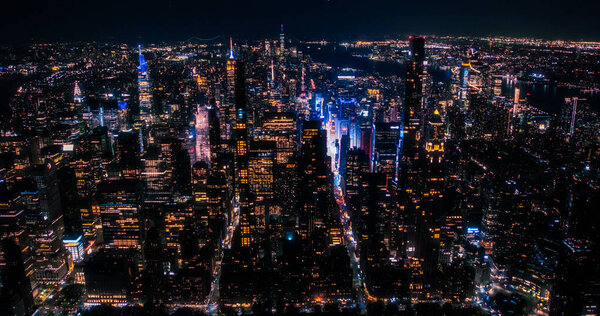 Aerial View of Midtown Manhattan Architecture at Night. Evening Shot of Financial Business District from a Helicopter. Scenery of Historic Office