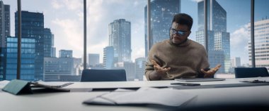 Dizüstü bilgisayar kullanarak, Gökdelen Ofisi 'ndeki bir masada Balck İşadamı' nı strese soktu. Yorgun Yönetici Karmaşık Mali Raporu Tamamlamadan Önce