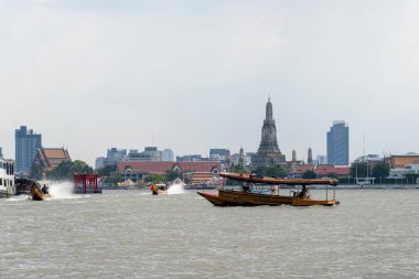 Wat Arun with the Chao Phraya River as foreground in Bangkok, Thailand