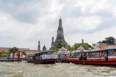 Wat Arun with the Chao Phraya River as foreground in Bangkok, Thailand