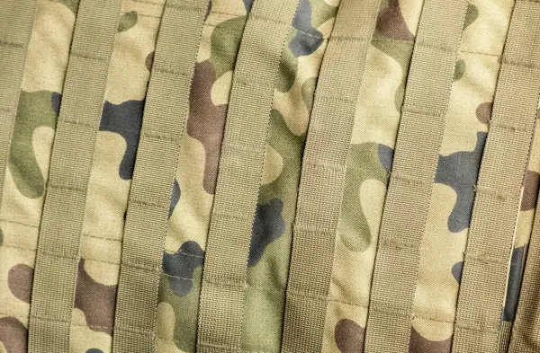 Professional generic green army military camo camouflage textile material with straps, full frame simple background texture, top view, nobody, backdrop wallpaper, clothes, bag military fabric up close