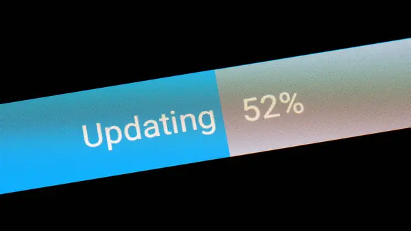 Generic updating system update process bar percentage meter on display, around 50 percent file transfer upload download progress macro extreme closeup screen detail, nobody, no people, technology