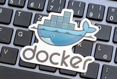 Docker logo placed over a laptop computer keyboard, Docker engine containers virtualization technology used in software development symbol, simple concept, nobody clipart