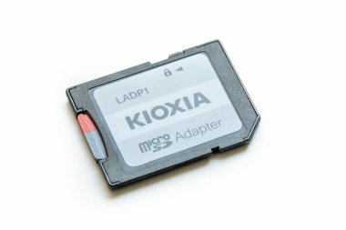Close-up view of a simple Kioxia brand microSD to SD card adapter object isolated on a white background, memory storage data card for photo video cameras, smartphones clipart