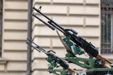 Closeup of a collection of vehicle-mounted machine guns with barrels pointing up, nobody. Urban warfare operations city war symbol, abstract concept no people, news shot. Conventional weapons up close clipart