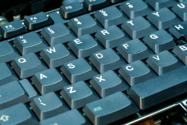 stock image Old thick keys on a retro laptop computer keyboard soft blue green tint vintage detail shot, nobody, retro computing old technology aesthetics concept, no people. QWERTY keyboard up close, shallow DOF