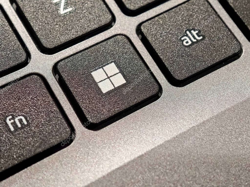 New Microsoft Windows 11 logo on a computer OS key, laptop keyboard macro detail, extreme closeup shot, nobody, no people. Windows operating system updates, new features