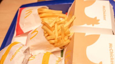 Mcdonald's fries and burgers closeup, fast food tray with Mcchicken sandwich packaging, french fries, convenience meal, quick service restaurant lunch or dinner, no people clipart