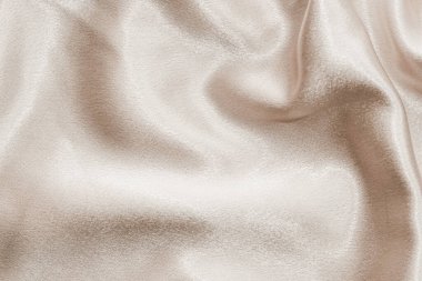 Beige silk fabric texture, Satin fashion Background for content.