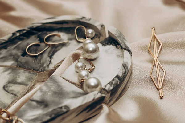 Women\'s jewelry, gold chain, trendy jewelry on a silk background.