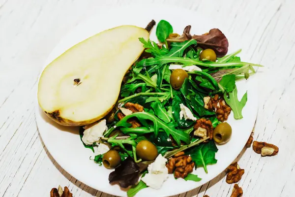 Armutlu salata, otlar, roka, prosciutto, peynir, yeşil zeytin ve fındık..