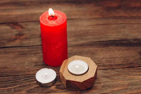 Multicolored candles, paraffin, wax and aromatic on a wooden table.
