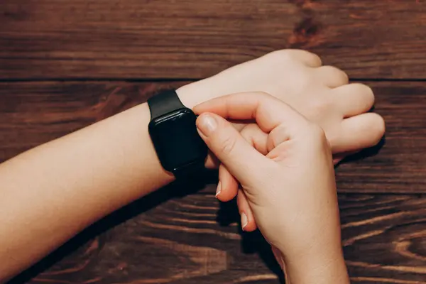 stock image Black technological smart watch in hand.