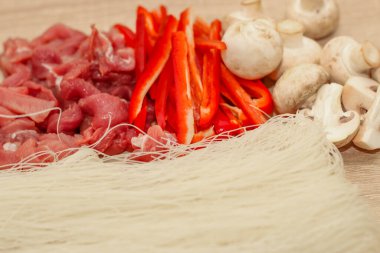 Dilimlenmiş et, mantar ve kırmızı biberli pirinç cam erişteli Funchoza..