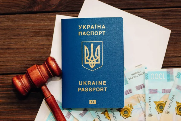 stock image Ukrainian hryvnia money on the table with documents with a place for text and a passport to Ukraine