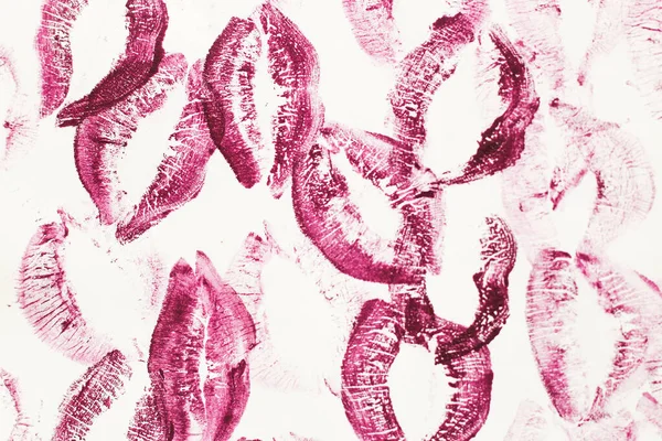 Lip prints of cosmetic lipstick on a light background.