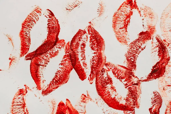 Lip prints of cosmetic lipstick on a light background.