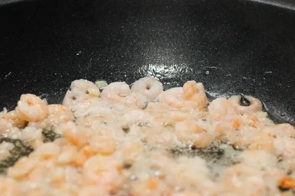 stock image Close-up of peeled, shelled boiled shrimp being fried.