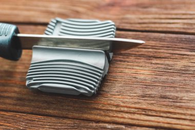 Ahşap arka planda elle keskinleştirici.