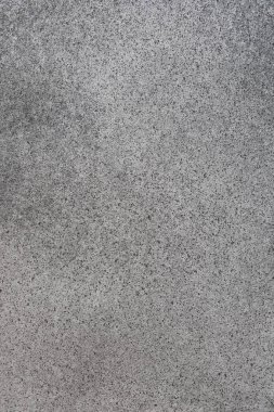 Gün ışığıyla aydınlanan ince desenler ve dokularla pürüzsüz, gri bir yüzeye yakın plan doğal varyasyonları gösteriyor..