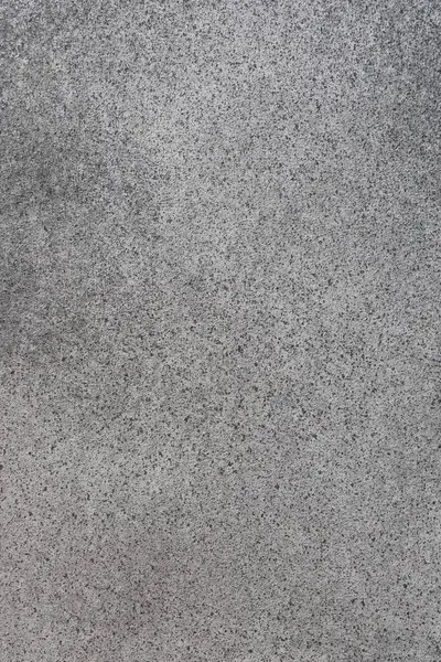 Gün ışığıyla aydınlanan ince desenler ve dokularla pürüzsüz, gri bir yüzeye yakın plan doğal varyasyonları gösteriyor..