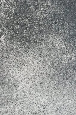 Karmaşık dokular ve grinin tonlarında ince farklılıklar gösteren beton bir yüzey görüntüsünü kapat.