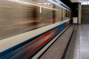 İstasyonda hız yapan tren, metruk bir tren peronunun uzunluğuna bakarak hareket bulanıklığı çeker.