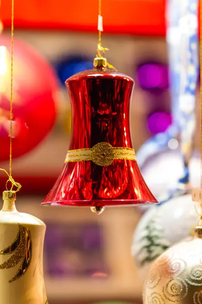 Colorful Bright Red Christmas Bell Ornament Hanging Amongst Assorted Baubles — Stock Photo, Image