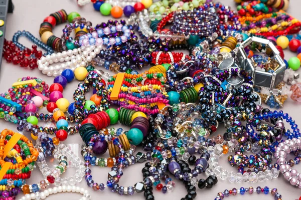Collection of colourful costume jewelry such as bracelets and necklaces made of glass and plastic beads. .