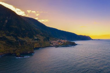 Aerial view of Seixal beach village at sunset. Seixal is a civil parish in the municipality of Porto Moniz in the Portuguese island of Madeira.