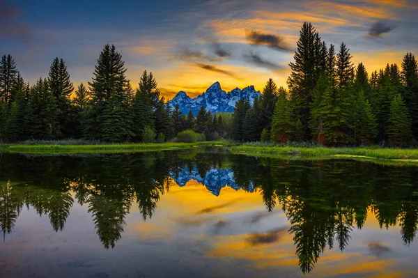 stock image Sunset over Schwabacher Landing with Teton Mountain Range reflected in the waters of Snake River in Wyoming, USA.