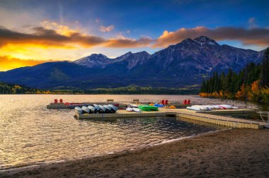 Sunset over jetty with boats on the Pyramid Lake in Jasper National Park, Alberta, Canada. clipart